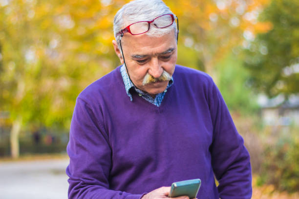 istock Senior man enjoying his smartphone outdoor. 875835608