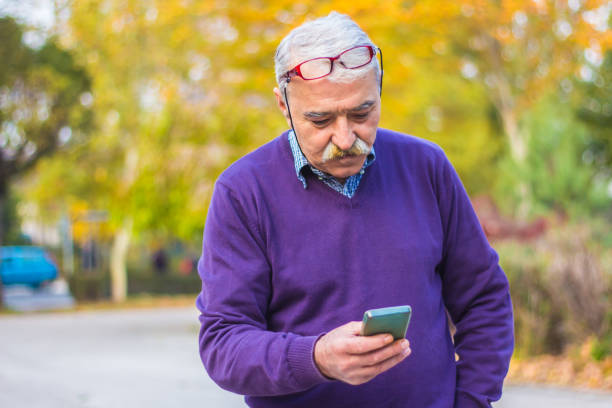 istock Senior man enjoying his smartphone outdoor. 875835708