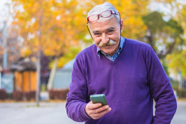 istock Senior man enjoying his smartphone outdoor. 875835794