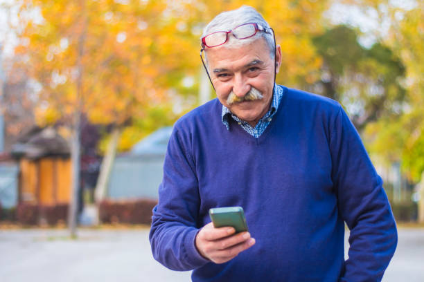 istock Senior man enjoying his smartphone outdoor. 875837888