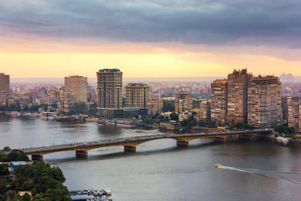 Bridge over the Nile river, along Which stand tall residential buildings.