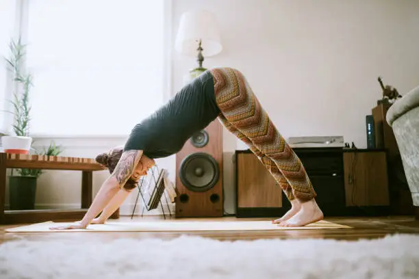 Photo of Young Adult Woman At Home Practicing Yoga
