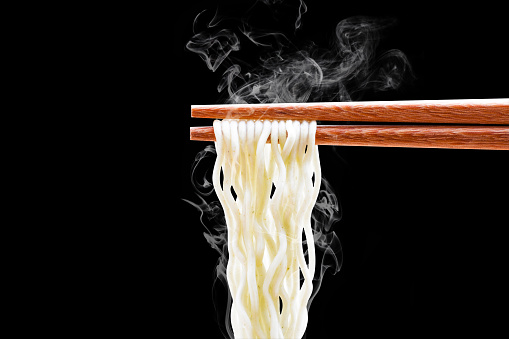 chopsticks noodles with smoke isolated on white background with clipping path