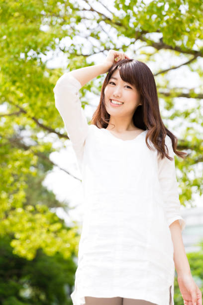 istock attractive asian woman relaxing in park 875858384
