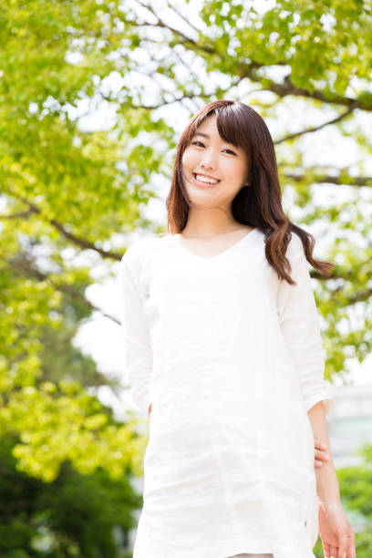 istock attractive asian woman relaxing in park 875858408