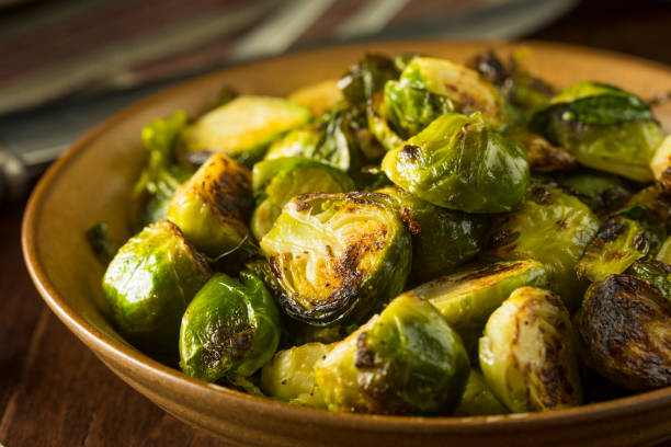 Homemade Roasted Green Brussel Sprouts Homemade Roasted Green Brussel Sprouts in a Bowl brussels sprout stock pictures, royalty-free photos & images