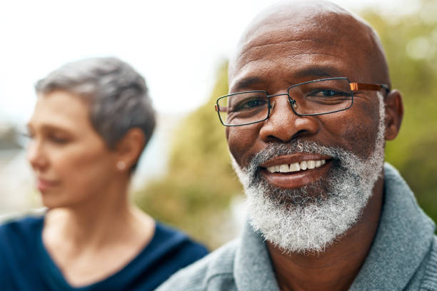 He's always happy Shot of a happy senior couple enjoying quality time at the park bald guys with beards stock pictures, royalty-free photos & images