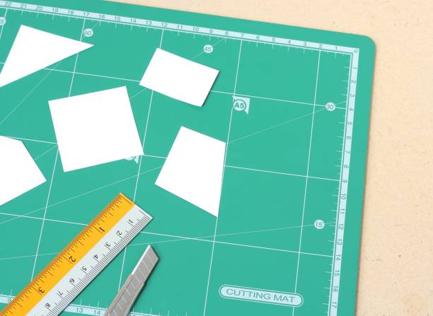 istock paper and green cutting mat. Cutter with ruler. 875904080
