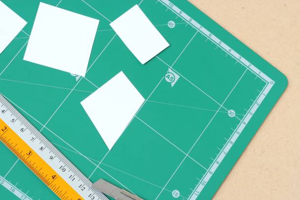 istock paper and green cutting mat. Cutter with ruler. 875904088