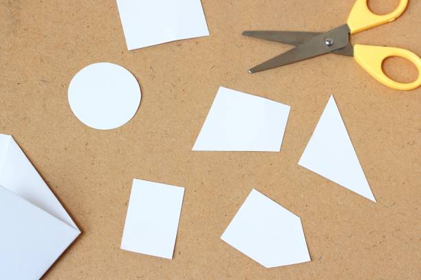 istock paper and Scissors on wooden background 875904110
