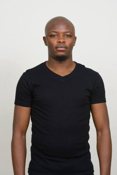 istock Young African man wearing black shirt against white background 875907070