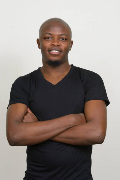 istock Young African man wearing black shirt against white background 875907266