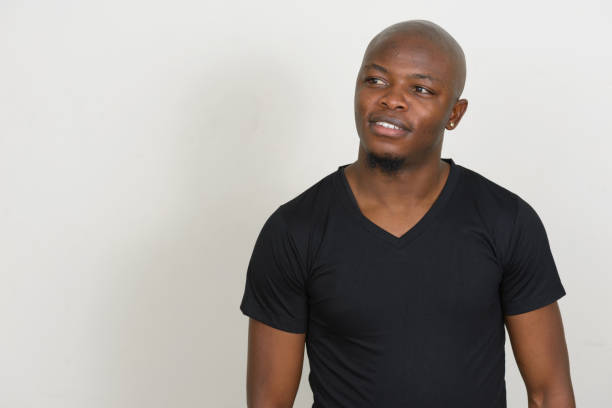 istock Young African man wearing black shirt against white background 875907694