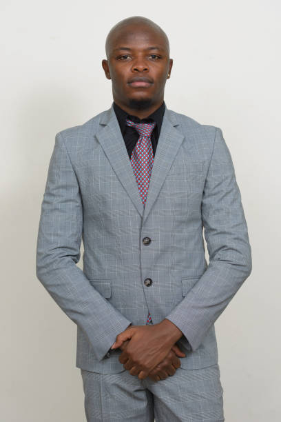 istock Young African businessman wearing suit against white background 875913282