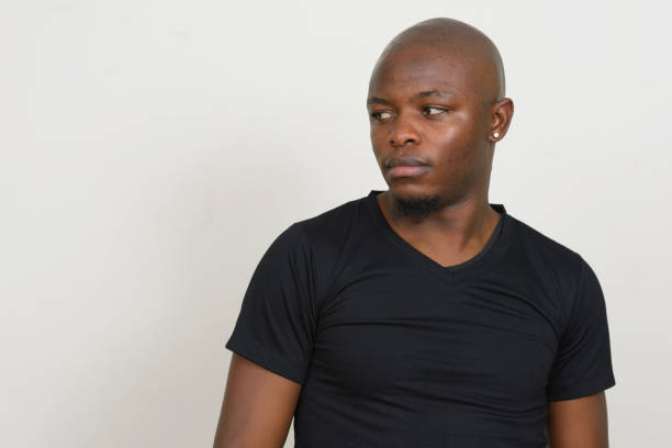 istock Young African man wearing black shirt against white background 875914380
