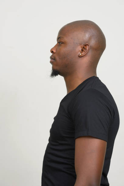 istock Young African man wearing black shirt against white background 875914714