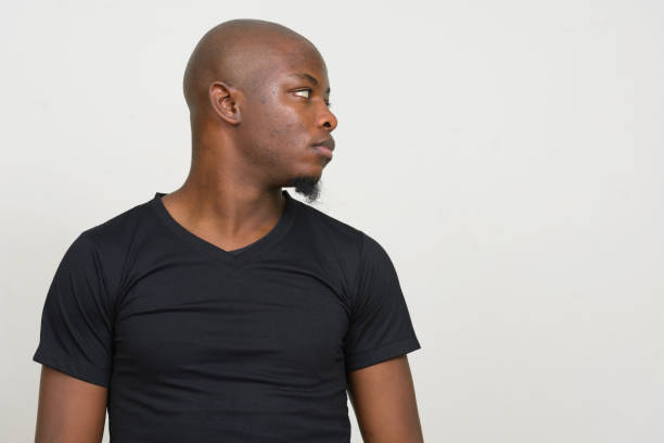 istock Young African man wearing black shirt against white background 875914792