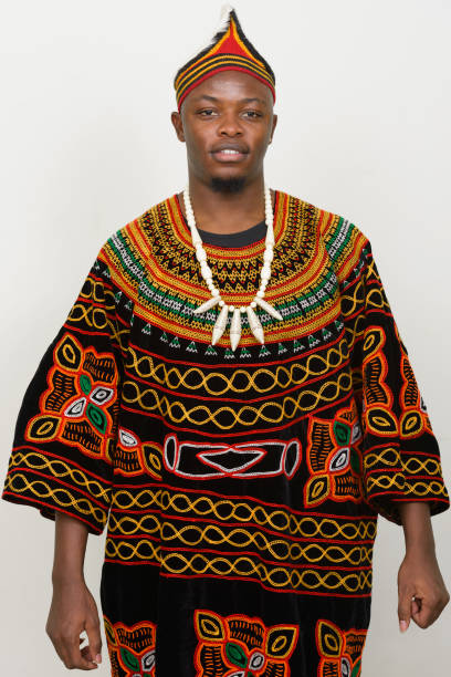 istock Young African man wearing traditional clothes against white background 875916982