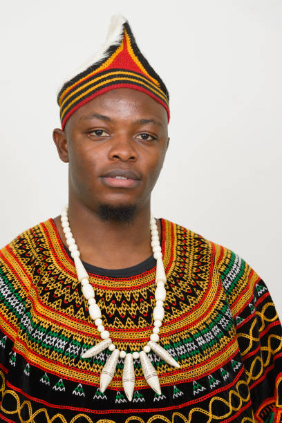 istock Young African man wearing traditional clothes against white background 875917000