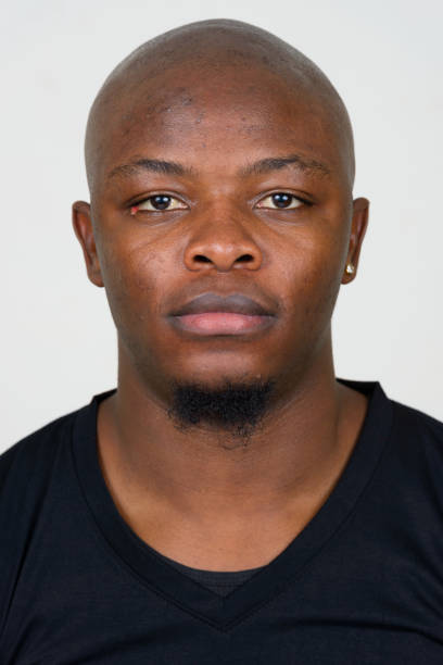 istock Young African man wearing black shirt against white background 875917222