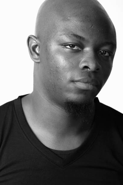 istock Young African man wearing black shirt against white background 875917398