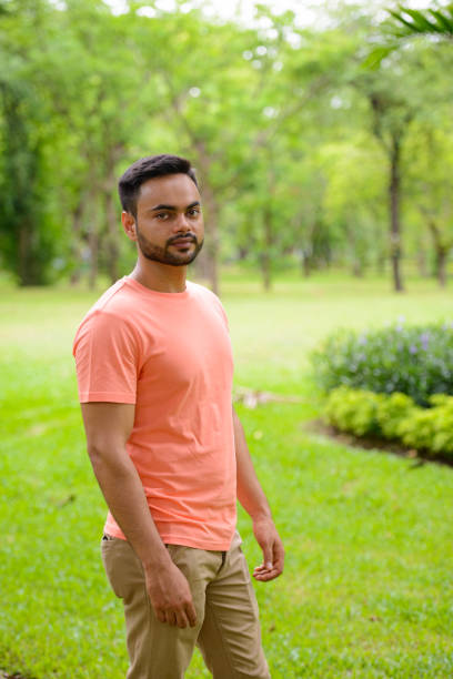 istock Young Indian man relaxing at the park 875928478