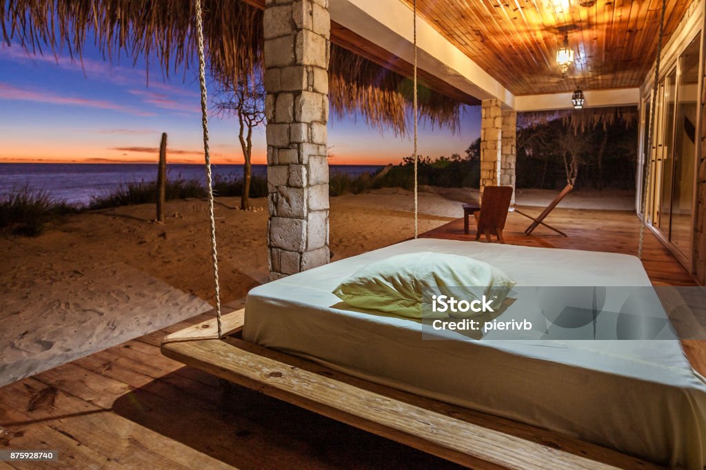 Terrace with sea view Terrace of a luxurious bungalow overlooking the lagoon at sunset in southwestern Madagascar Bedroom Stock Photo