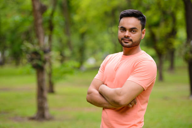 istock Young Indian man relaxing at the park 875932152