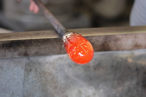 istock Molten glass on a rod for glass blowing macro 875932434