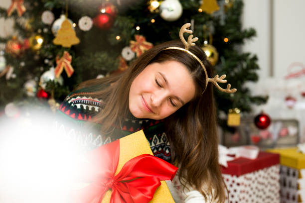 istock Girl with a Christmas present 875932748