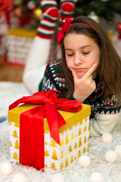 istock Girl with a Christmas present 875932804
