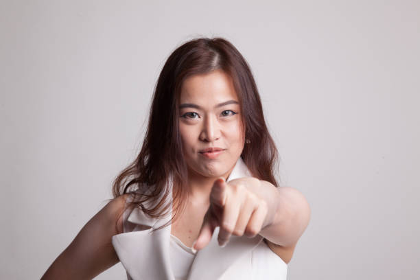 istock Young Asian woman angry and point to camera. 875935062