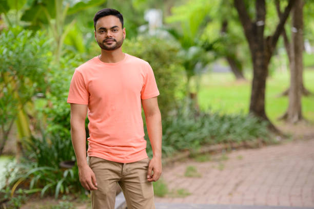 istock Young Indian man relaxing at the park 875935208