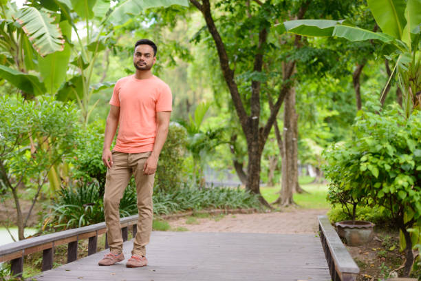 istock Young Indian man relaxing at the park 875935402