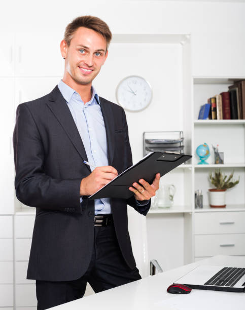 istock Business man with cardboard in office 875943796
