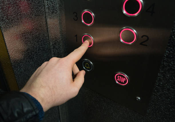 Man pressing button inside elevator. Man pressing button inside elevator. Phobia stock pictures, royalty-free photos & images