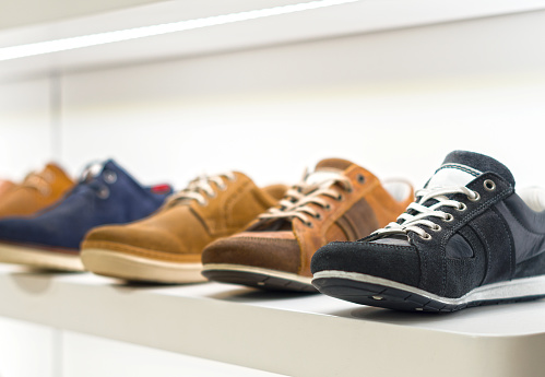 Collection of men's shoes in the store.