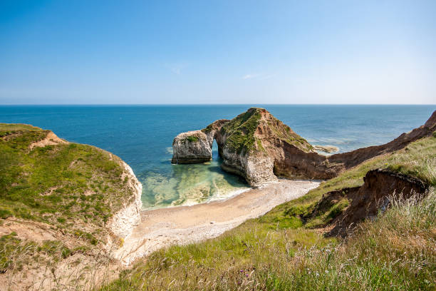 Chalk Arch formation on coast at Selwick Bay near Flamborough Head in Yorkshire Chalk Arch formation on coast at Selwick Bay near Flamborough Head in Yorkshire east riding of yorkshire photos stock pictures, royalty-free photos & images