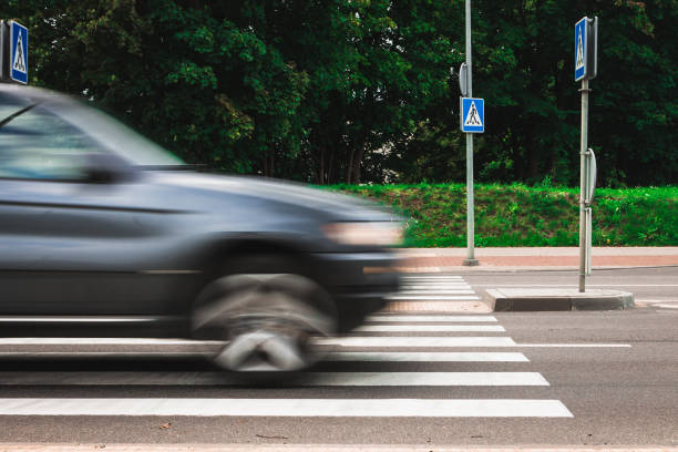 istock A black machine at high speed crosses a pedestrian crossing, a m 875947776