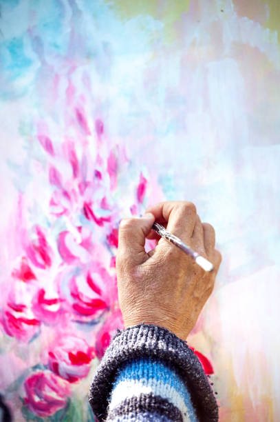 Woman Hand Painting on Canvas - Close-up