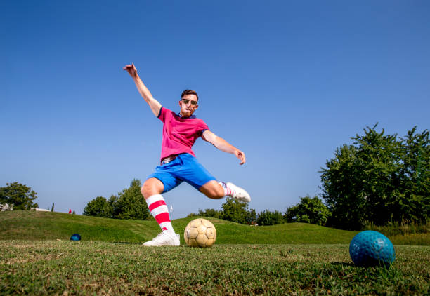 istock Footgolf Player Kicking Soccer Ball 875952140