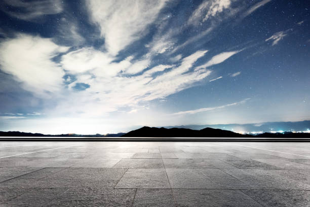 istock empty marble floor with green hill in star sky 875952632