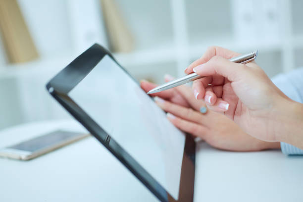 istock Two business colleagues working together with tablet in office. 875953206