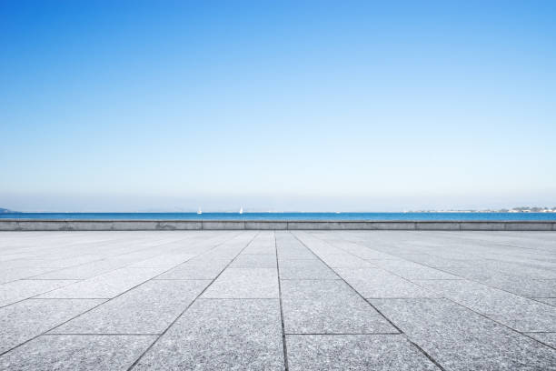 istock empty marble floor with blue sea in blue sky 875955734