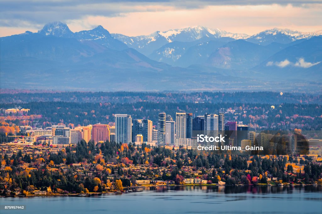 Aerial view of Bellevue, Washington Bellevue, Washington. The snowy Alpine Lakes Wilderness mountain peaks rise behind the urban skyline. Bellevue - Washington State Stock Photo
