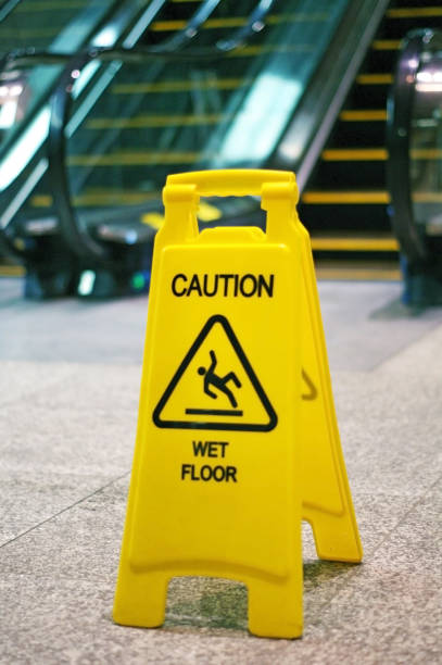 istock Indoor escalator with slippery when wet sign on floor 875964880