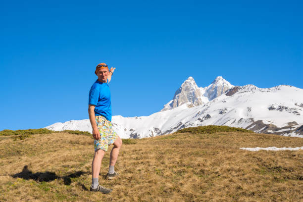 istock Joyful traveler walks along the mountain slope 875980436