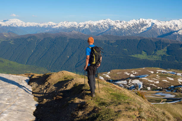 istock Traveler admires snow covered mountain ranges 875980446