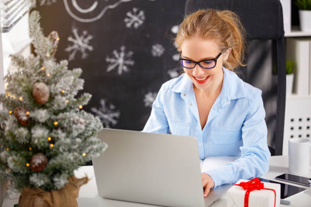istock businesswoman freelancer working at a computer at Christmas 875980700