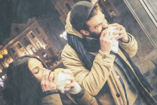 istock Couple eating burger aon the street 875981168